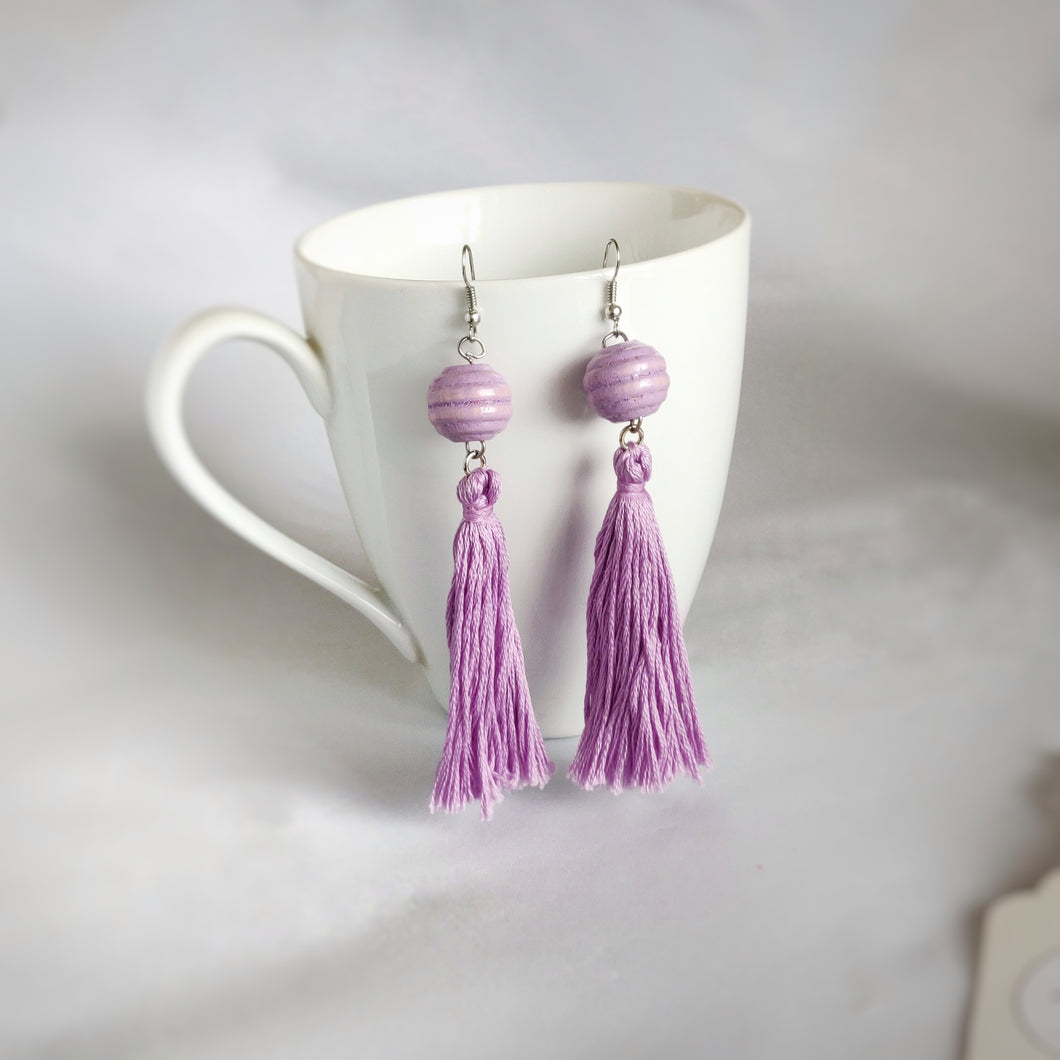 Purple Tassels, Purple Beads, Dangle Earrings hanging on a cup