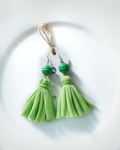 A pair of green tassel dangle earrings made with re-purposed cotton T-shirts and green wooden beads