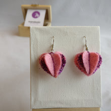 A pair of pink felt with purple glitter heart shaped dangle earrings